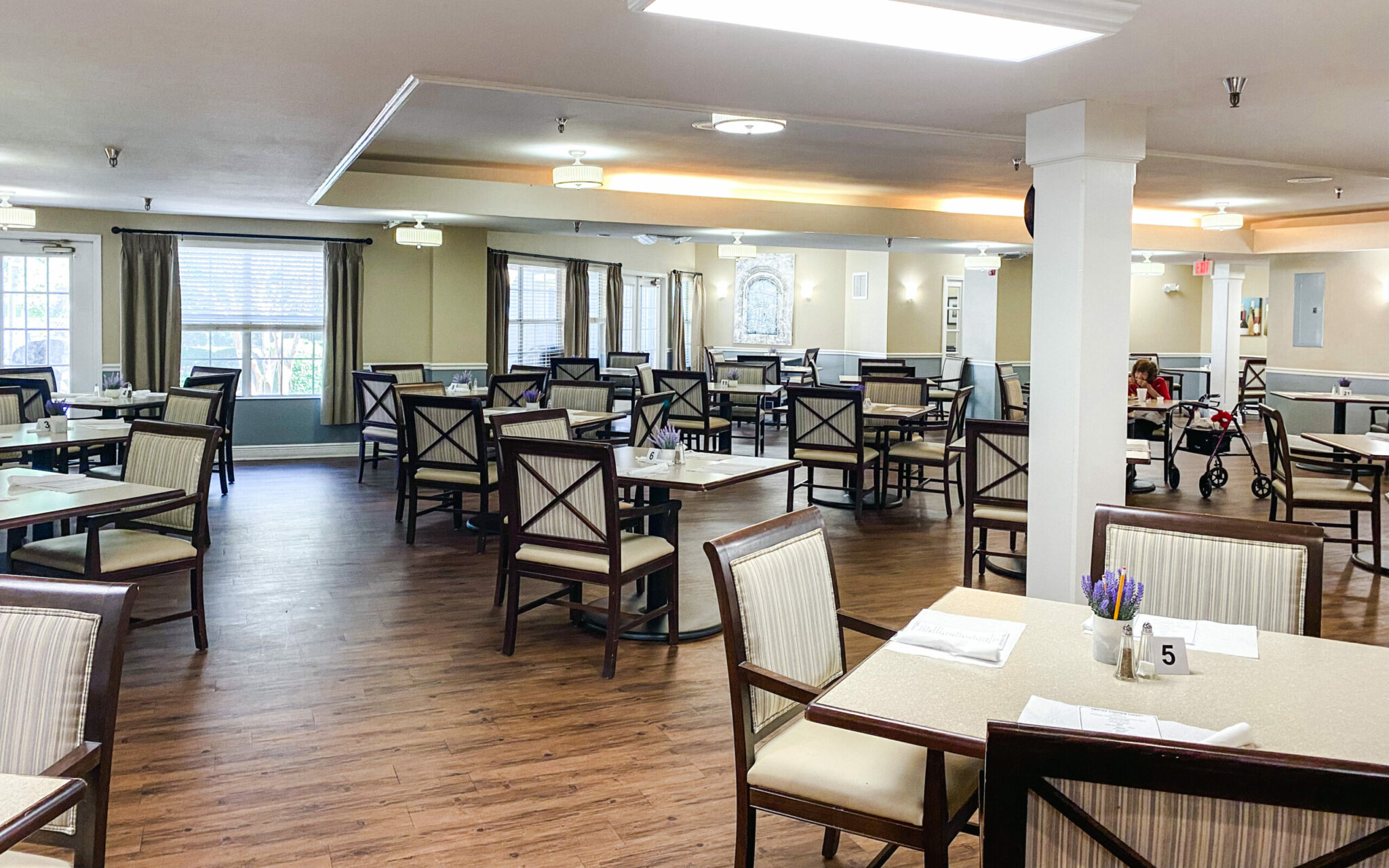 Dining room space with multiple tables and chairs at The Waterford at Carpenter's Creek