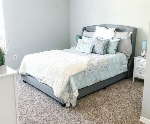 model apartment bedroom with fan, side table and queen size bed