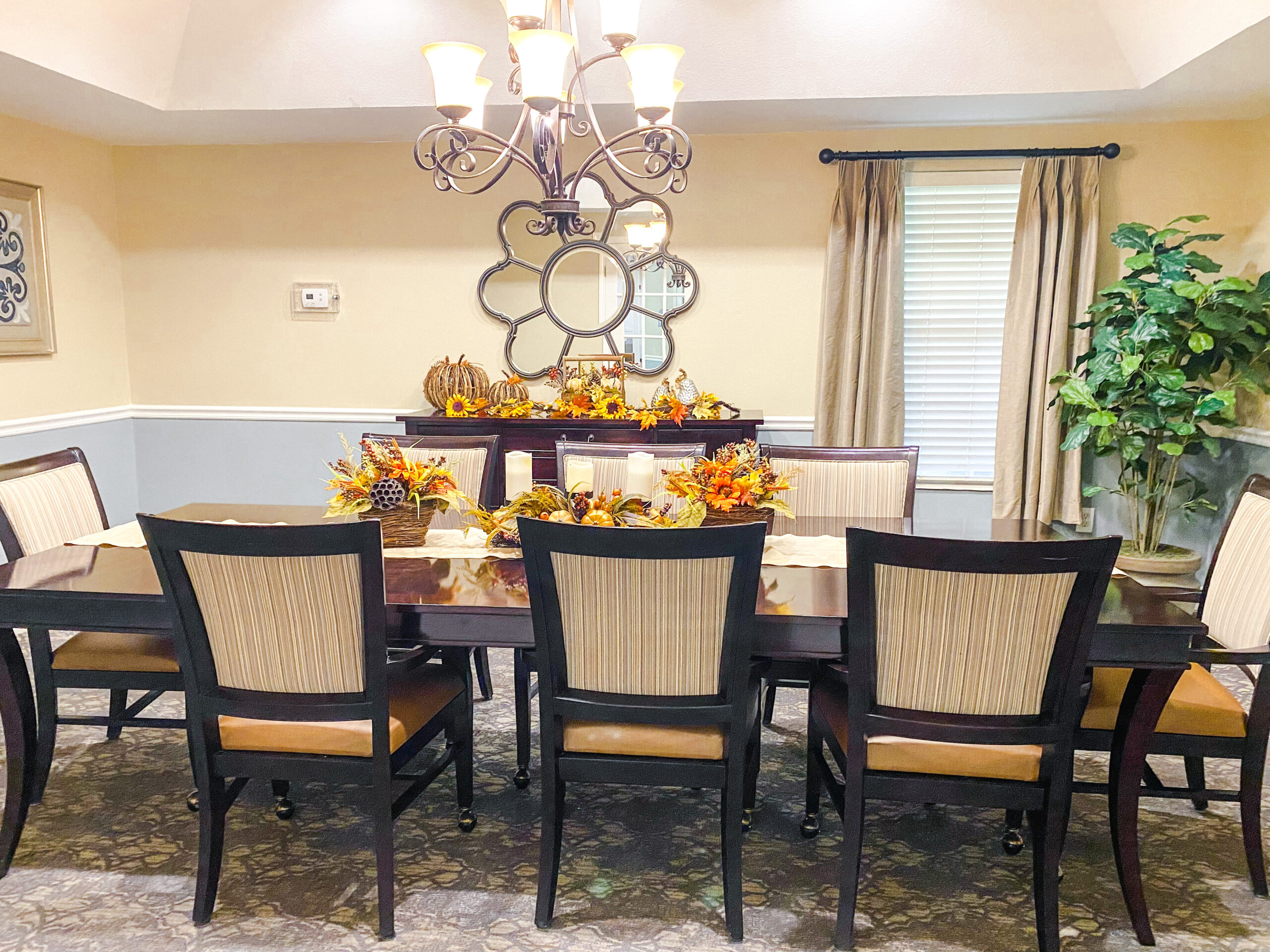 private dining room with tables and chairs near a window and chandelier