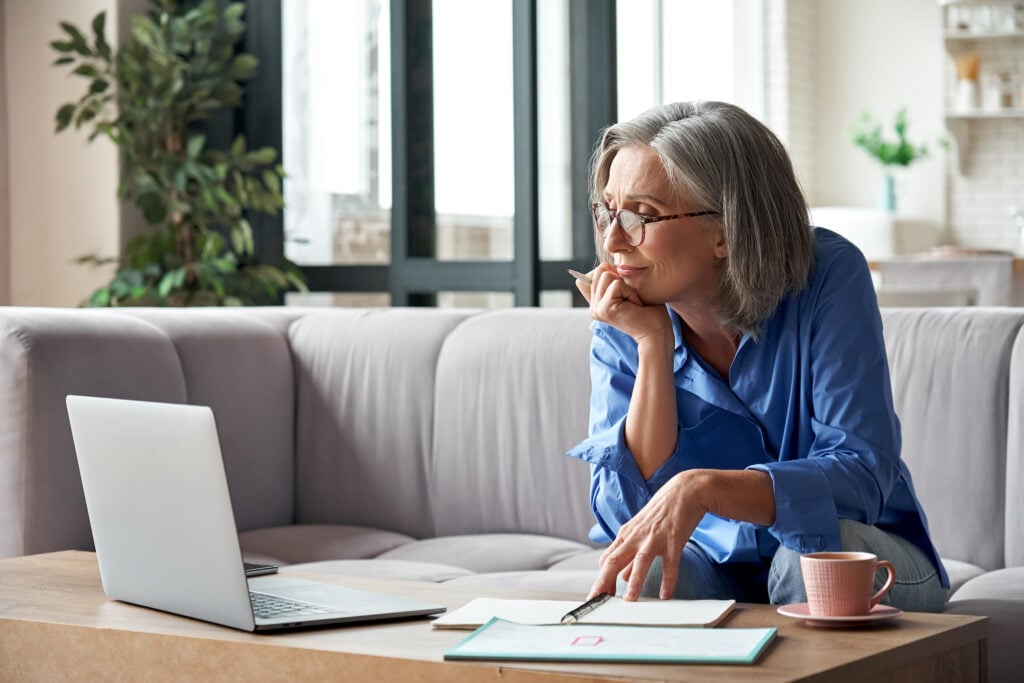 senior woman looking at computer for medicare