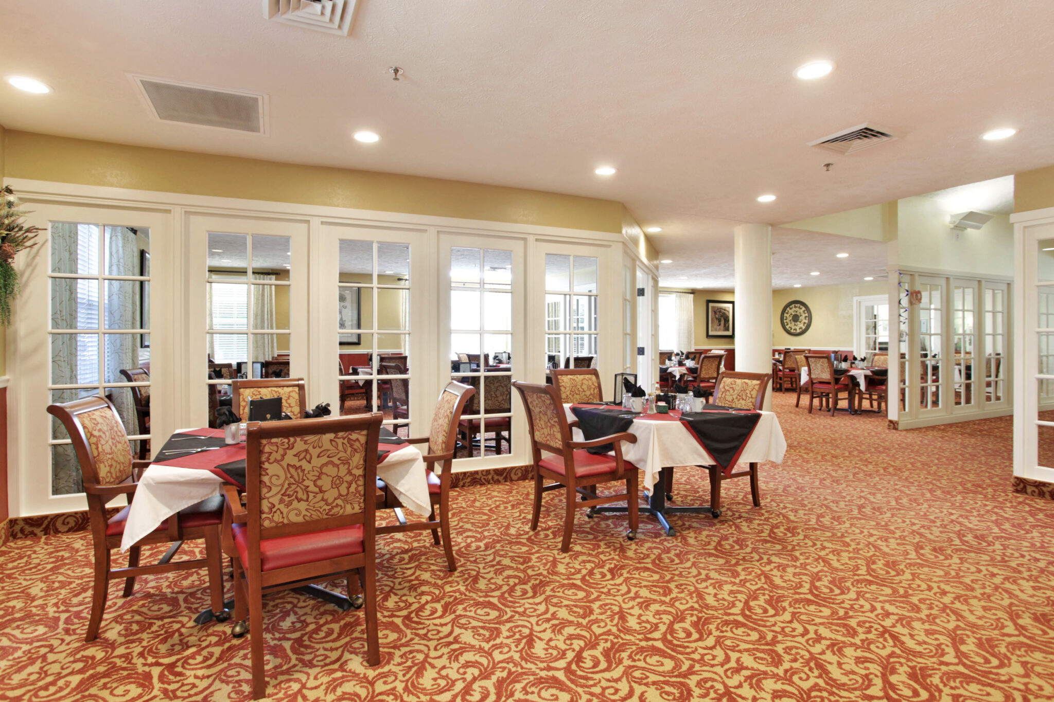 The dining room at Southern Meadows has multiple tables and chairs for seniors to enjoy meals together