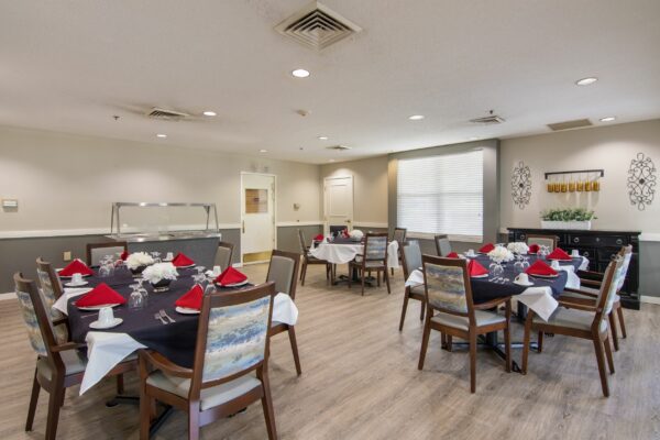 dining room space with multiple tables and chairs at willow grove of maumelle