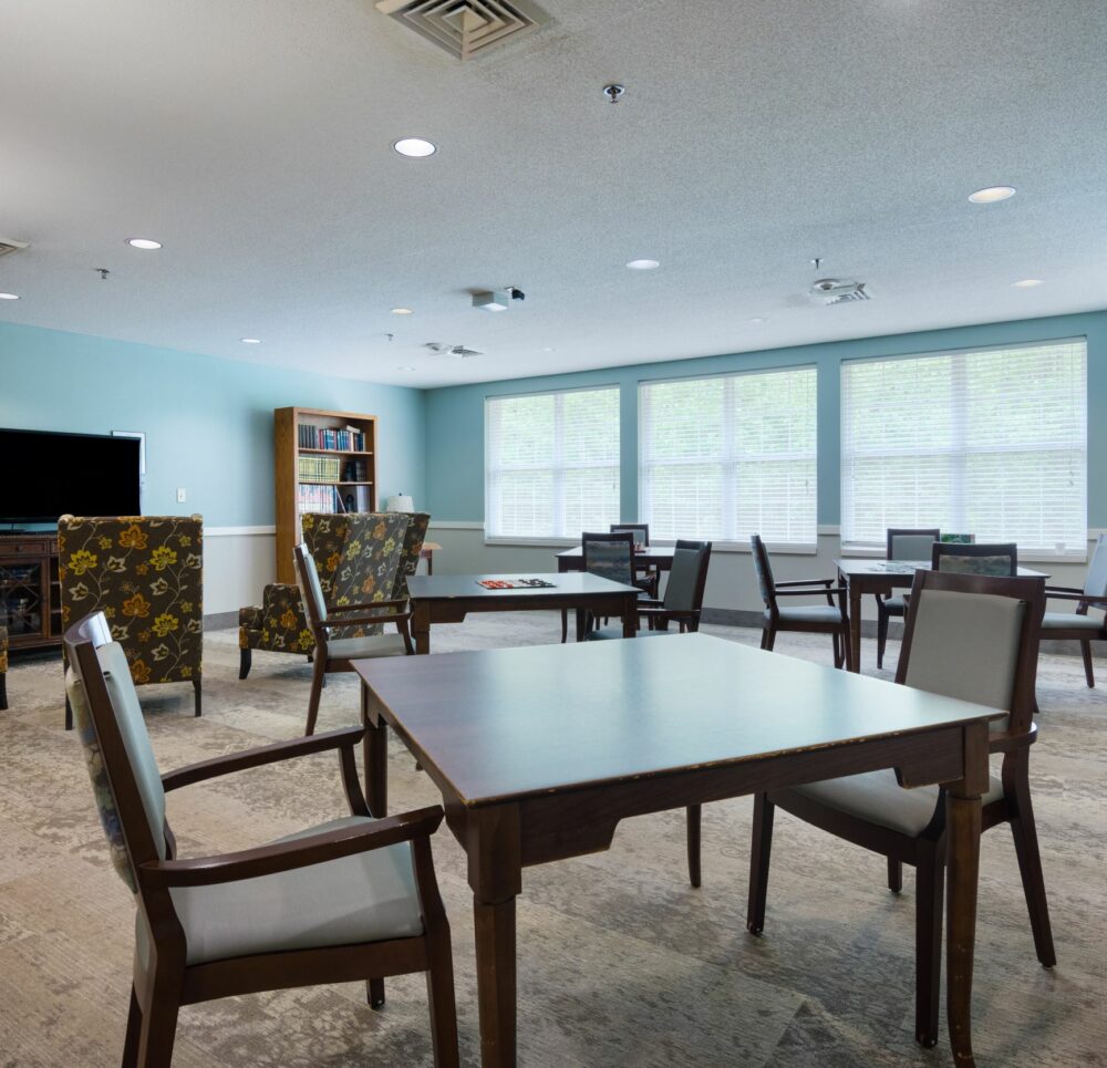 game room with chairs, tables and a large-screen TV