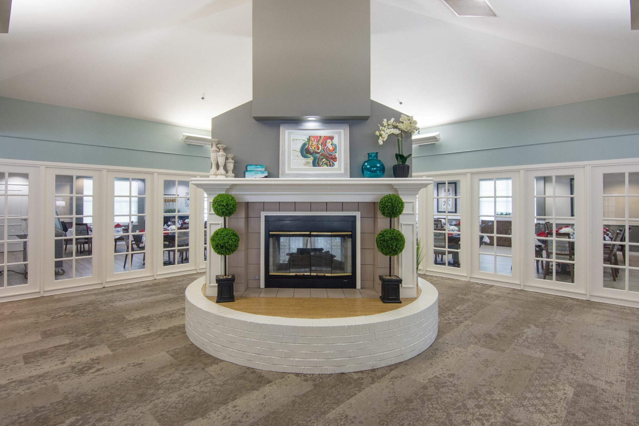 Lobby with a large fireplace in front of the dining room