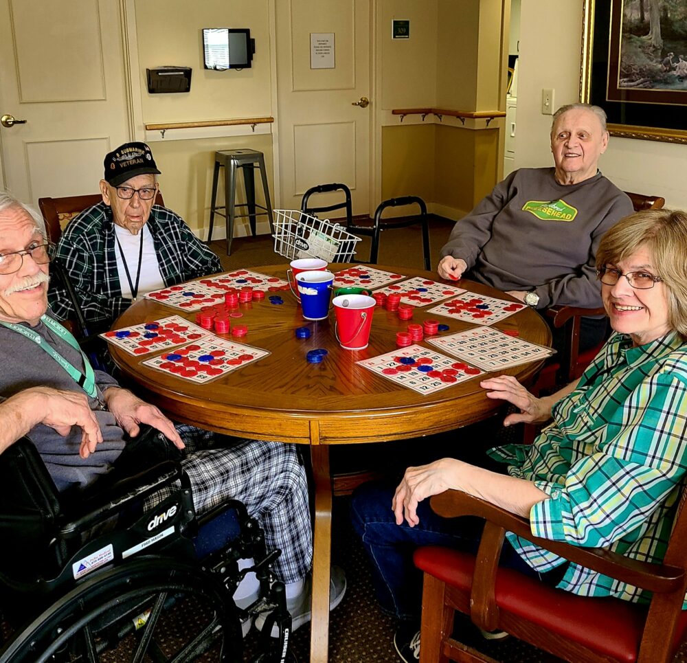 four seniors play bingo together