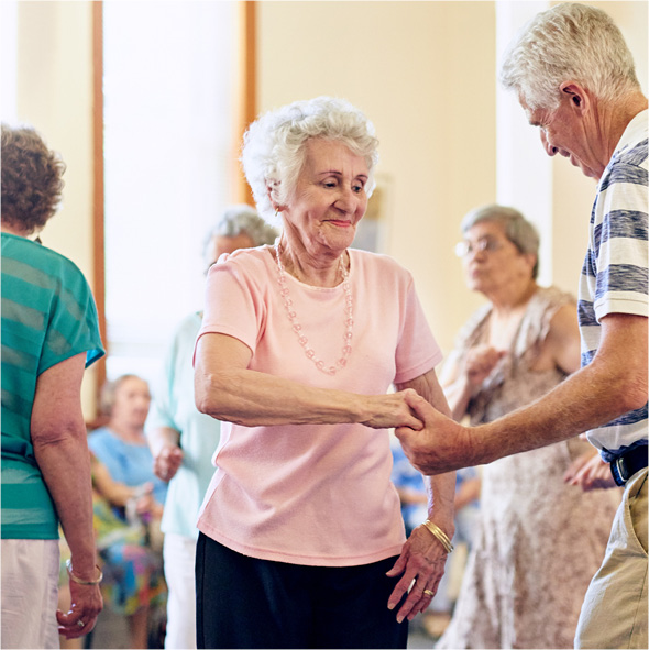 Senior residents participating in a dance class at an assisted living facility operated by Sonida Senior Living.