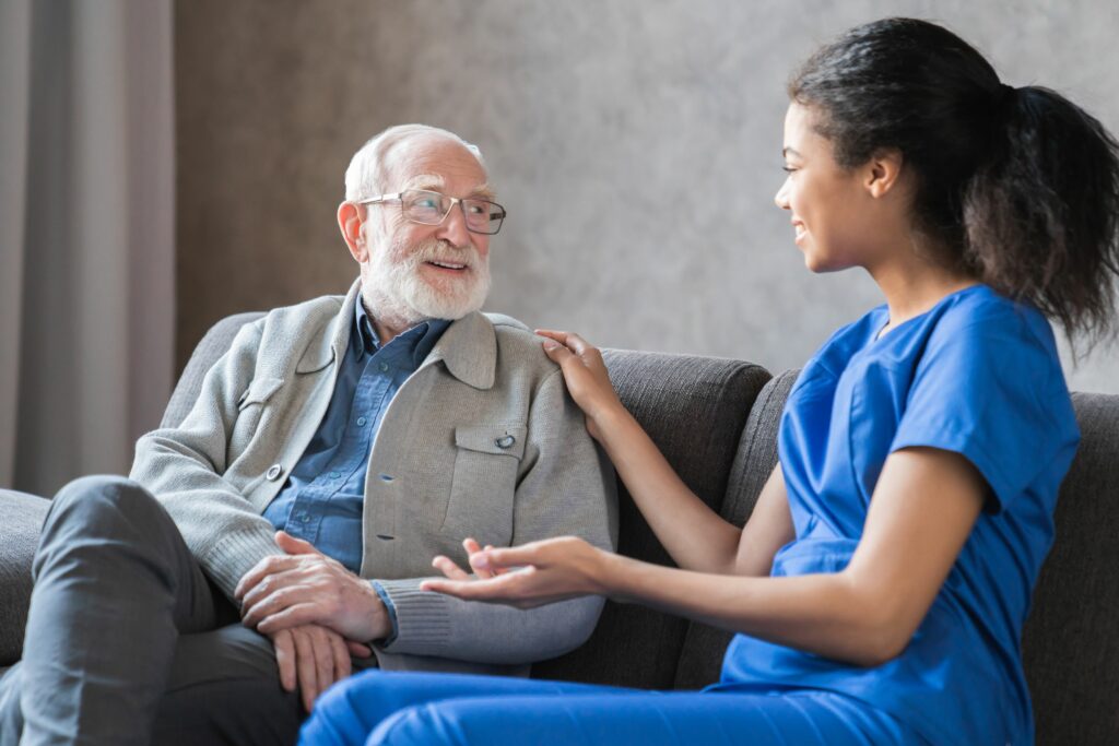 Young african nurse helping senior old elderly man grandfather