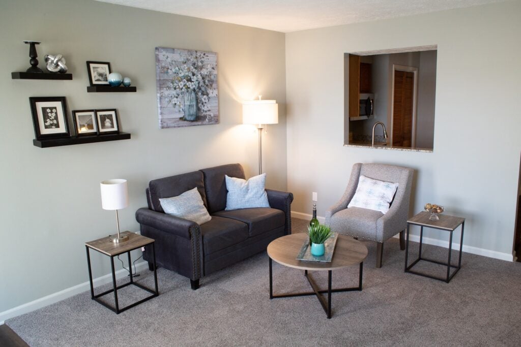 apartment living room with couch and chairs overlooking the kitchen
