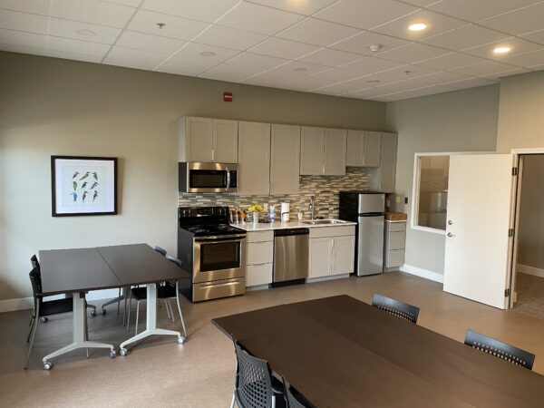 activities room with seating and a public kitchen to use
