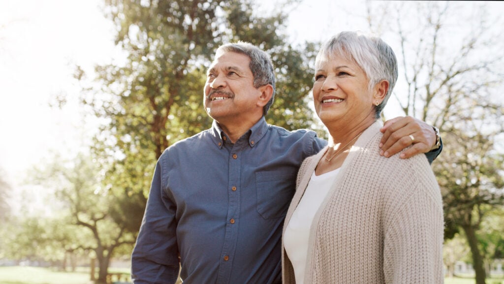 senior man has his arm around a senior woman