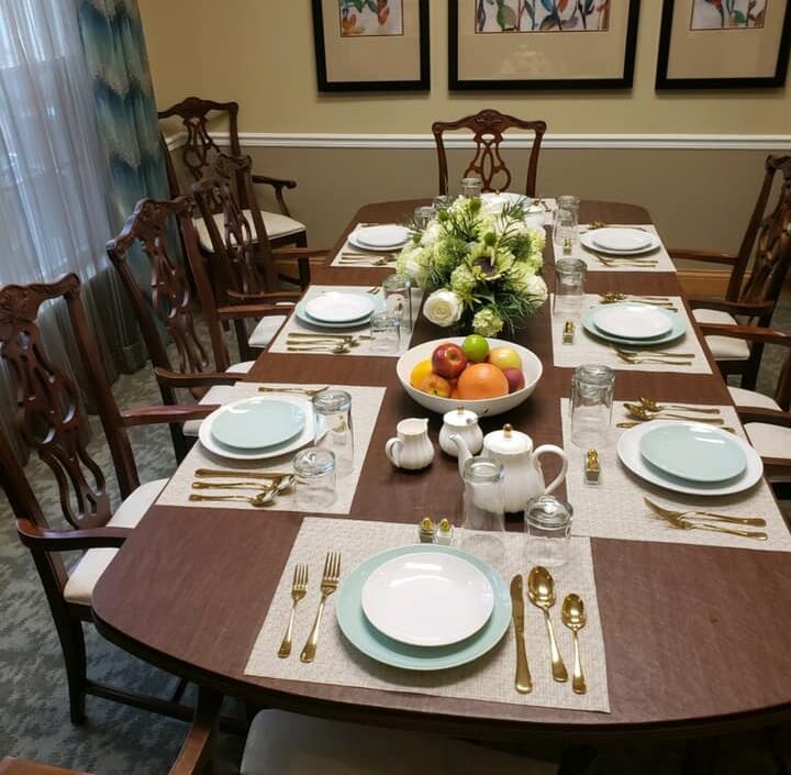 private dining room with chairs surrounding a long brown table