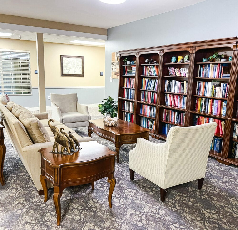 book shelf near couch and chairs at the waterford at carpenters creek
