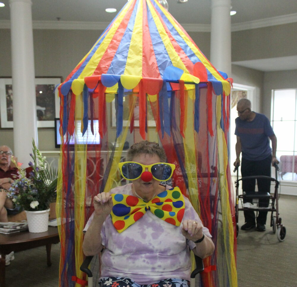senior woman poses under a carnival canopy