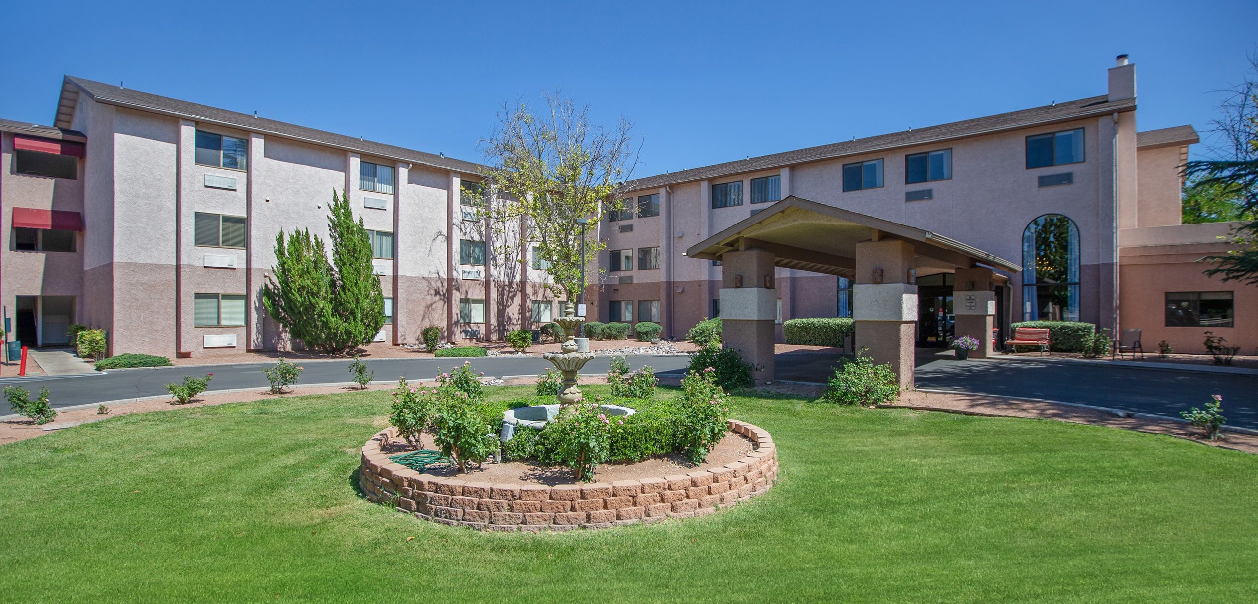 Front facade of a senior living community in Cottonwood, Arizona with covered entrance.