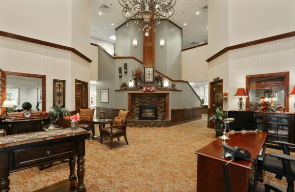 lobby area with a fireplace, receptionist desk and seating