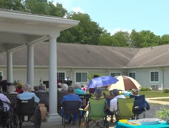 seniors sit outside during a church service