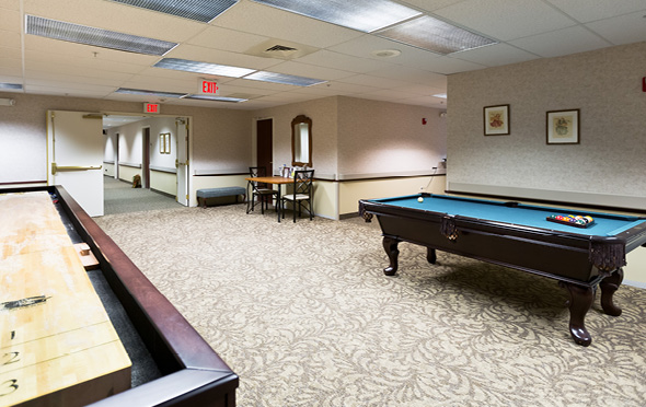 Marquis Place of Elkhorn senior living community activity center with billiards table and other games.