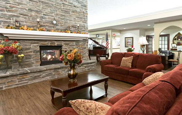 Marqus of Elkhorn senior living community lounge with fireplace and comfortable couches.