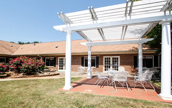 North Pointe senior living community outdoor courtyard with table and chairs.