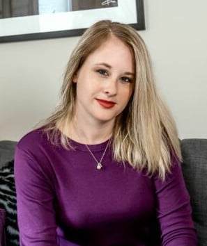 woman in purple shirt sitting on a couch