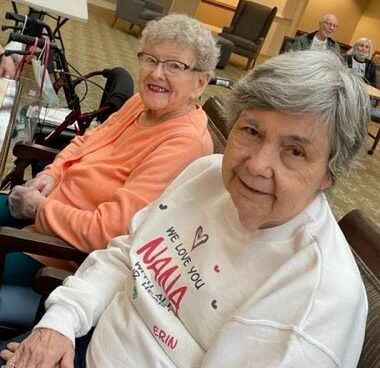 two senior women smile for the camera