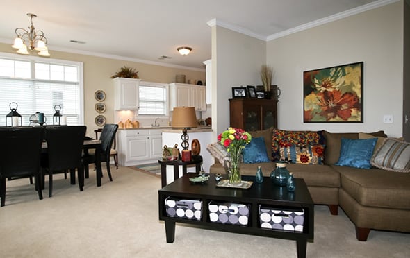 Model apartment with living room and kitchen at a senior living community.