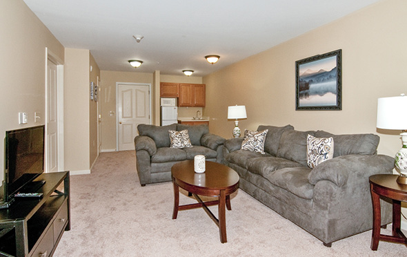 Model apartment living room at a senior living community.