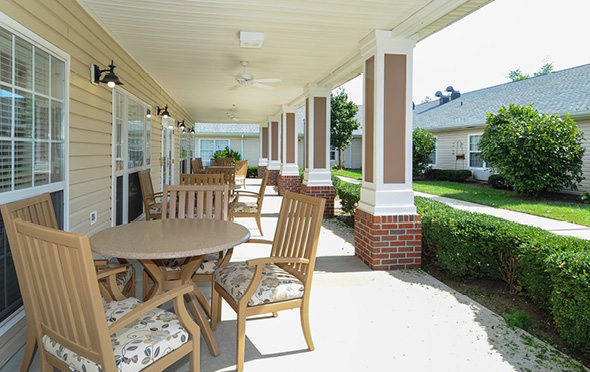Outdoor courtyard with covered seating area at a senior living community.