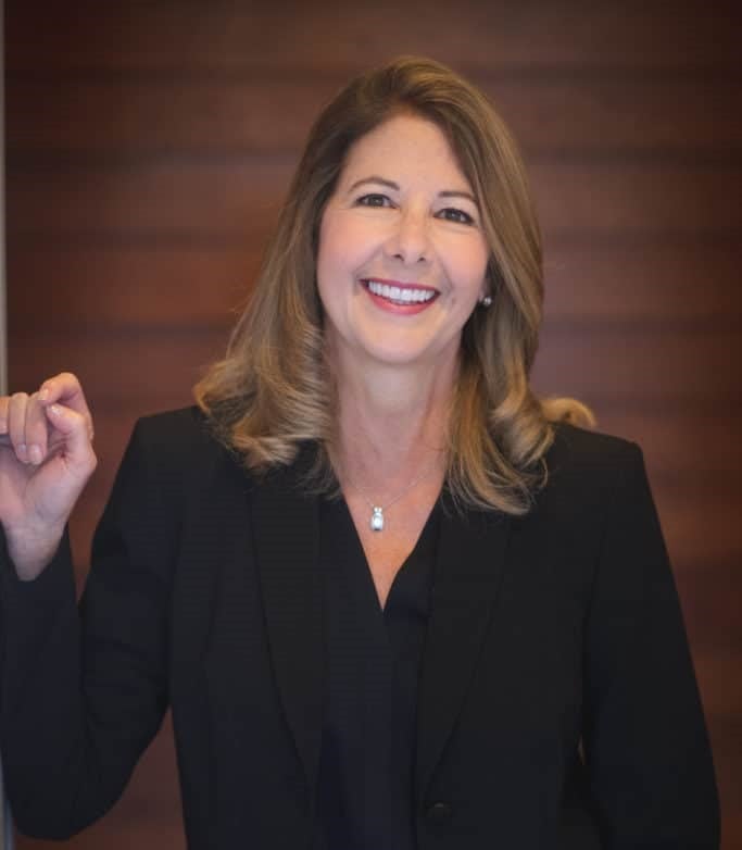 middle-aged woman poses with a professional background