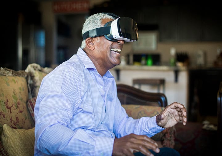 Senior Black Man Using Virtual Reality Headset in Living Room