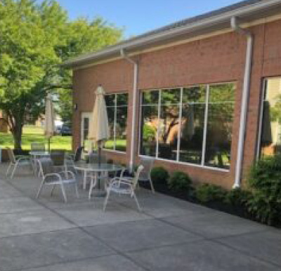 Outside courtyard with tables and chairs at a senior living community in Fairfield, Ohio.