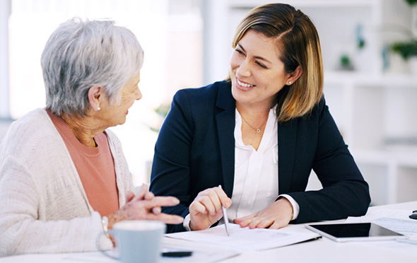 Smiling financial advisor meeting with a senior woman