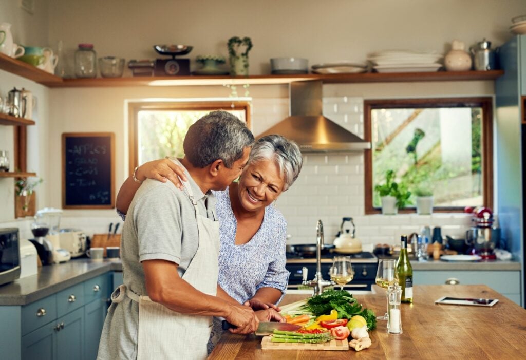 Shot of a happy mature couple cooking a meal together at home