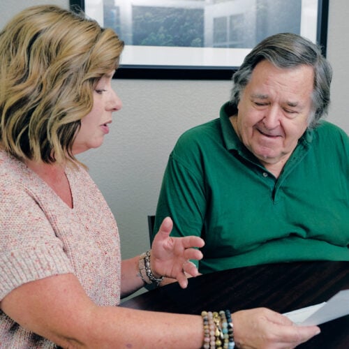 Adult woman explains senior living costs to her older father