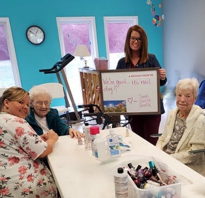 Senior women getting their nails done at their retirement home’s beauty salon in Greencastle, Indiana.
