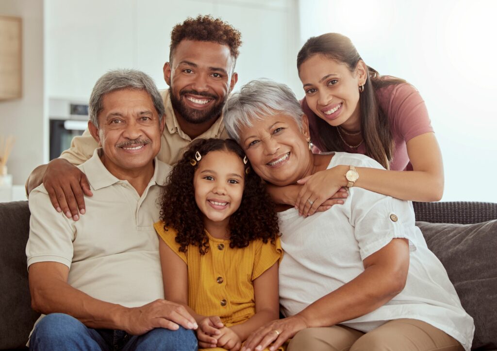 Portrait of mixed race family enjoying weekend in living room at home.