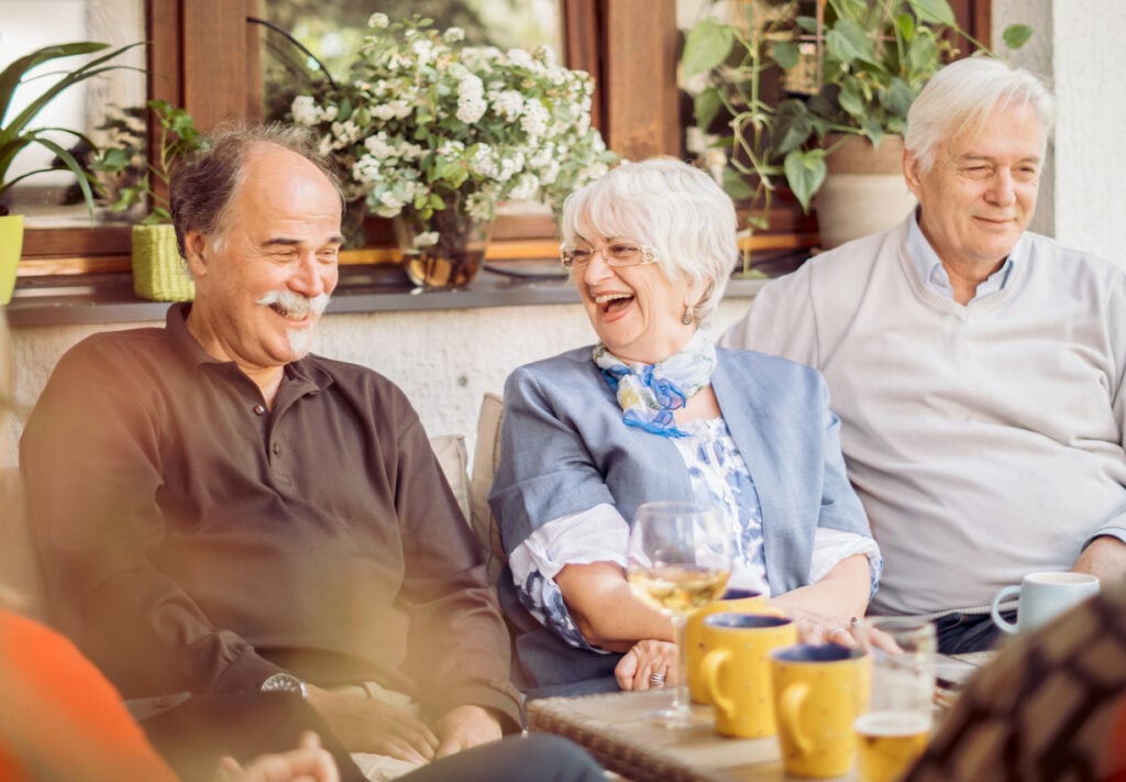 Group of older adult's discounts enjoying food at a dining table