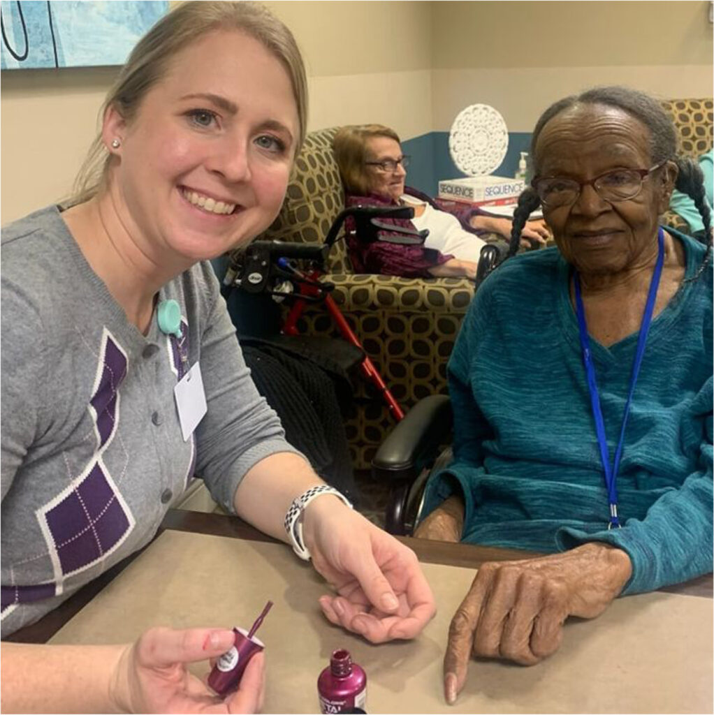 A resident getting pampered with a manicure by a Magnolia Trails team member.