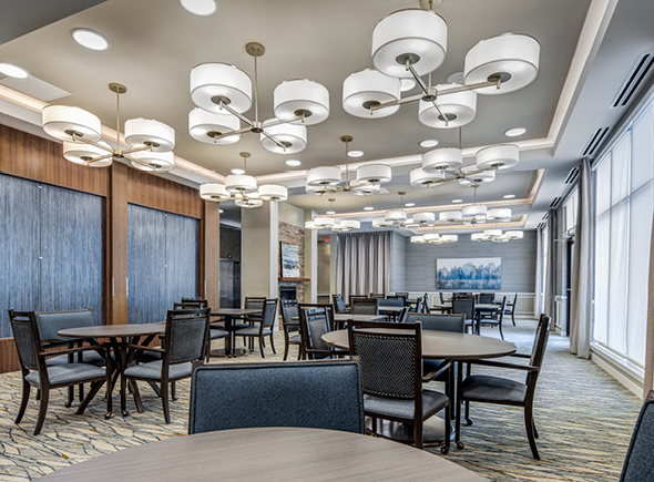 The dining area at The Ashton at Mayfield Heights has tables and chairs for seniors to eat meals
