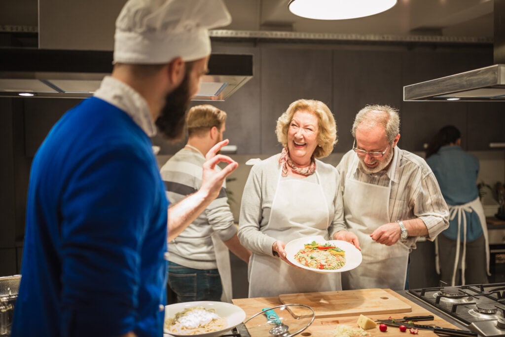 Chef is supervising attendees of cooking class