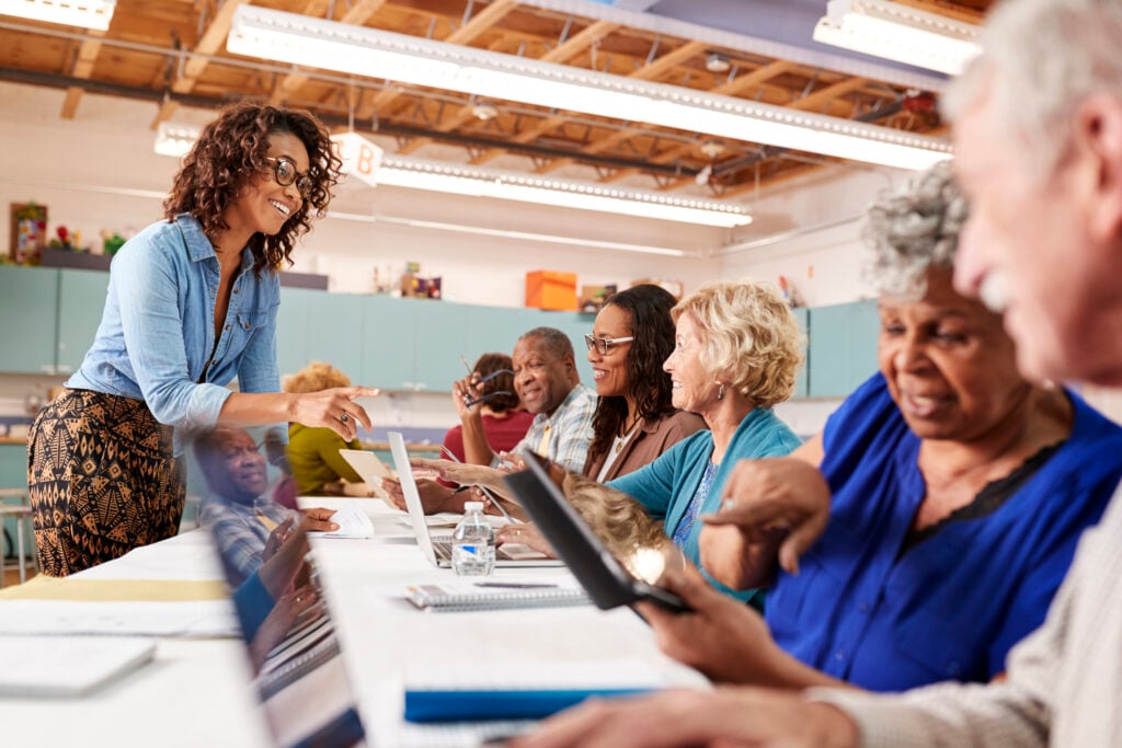 Group Of Retired Seniors Attending IT Class