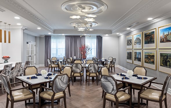 The Ashton on the Plaza dining room has many tables and chairs for seniors to enjoy meals