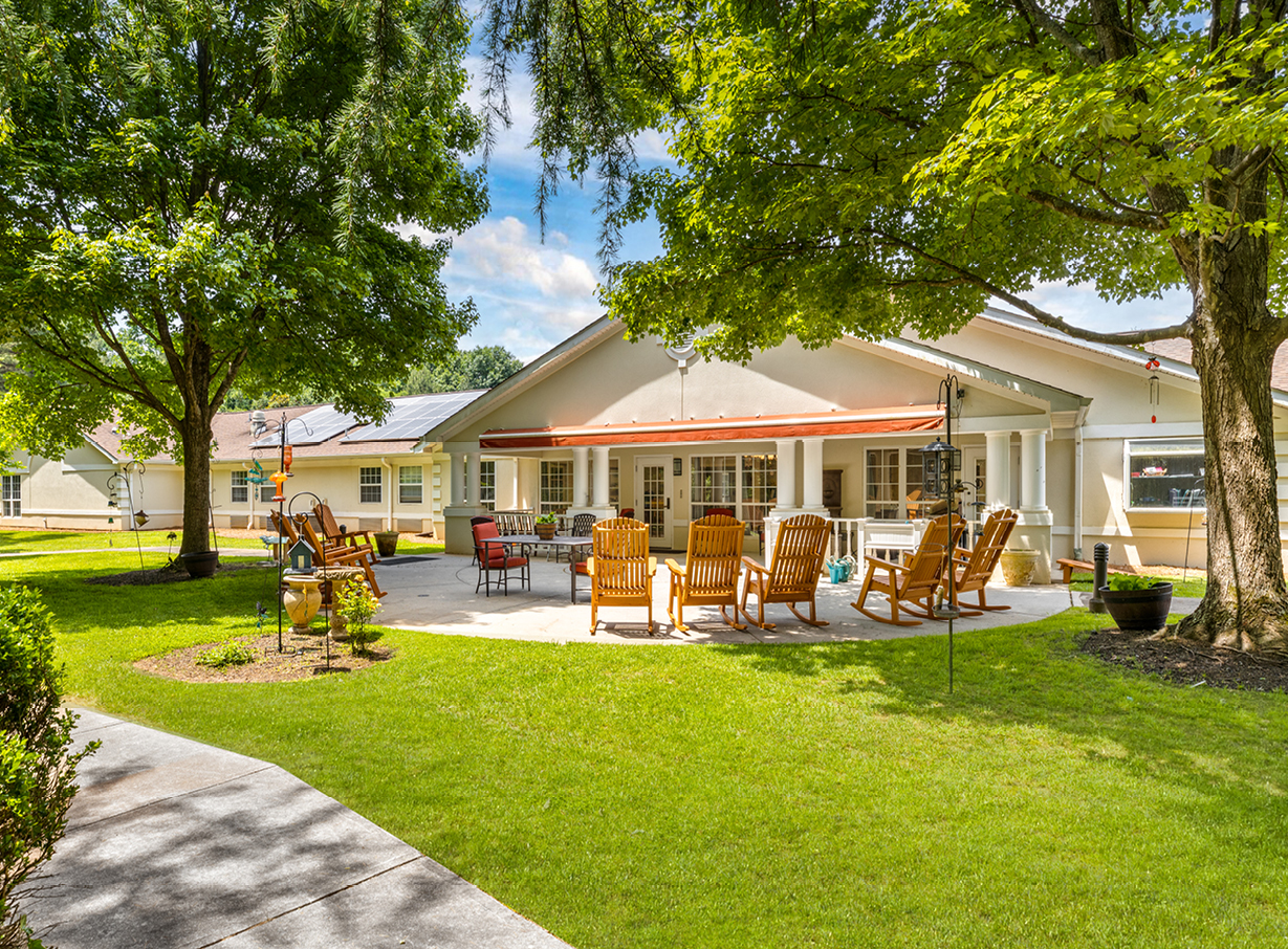 The Waterford at Decatur front courtyard has shaded seating near large trees