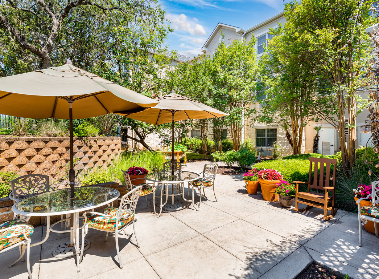 The Waterford at Shavano Park courtyard has many trees, plants and places to sit