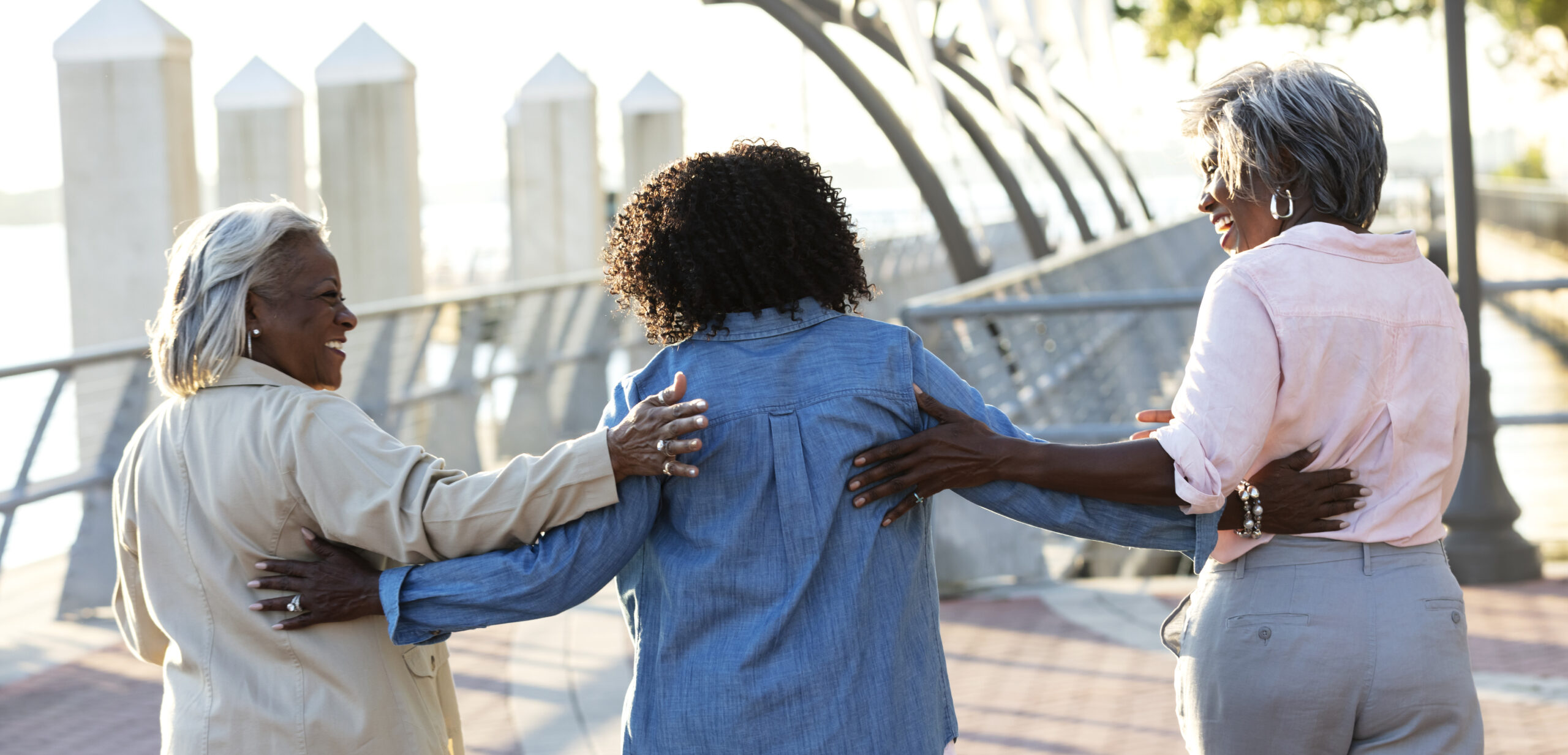 senior women talking on city waterfront
