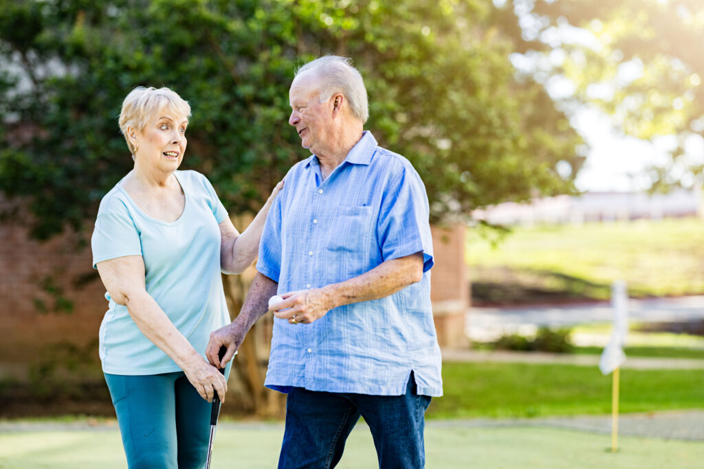Senior couple playing golf together