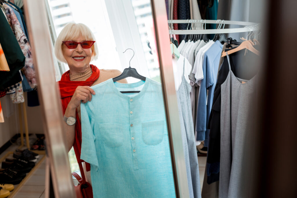 Stylish elderly woman in front of shopping mirror