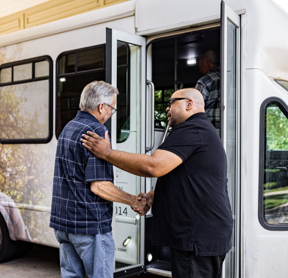 Caregiver and resident entering a vehicle