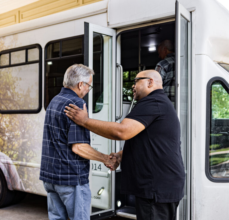 Caregiver and resident entering a vehicle