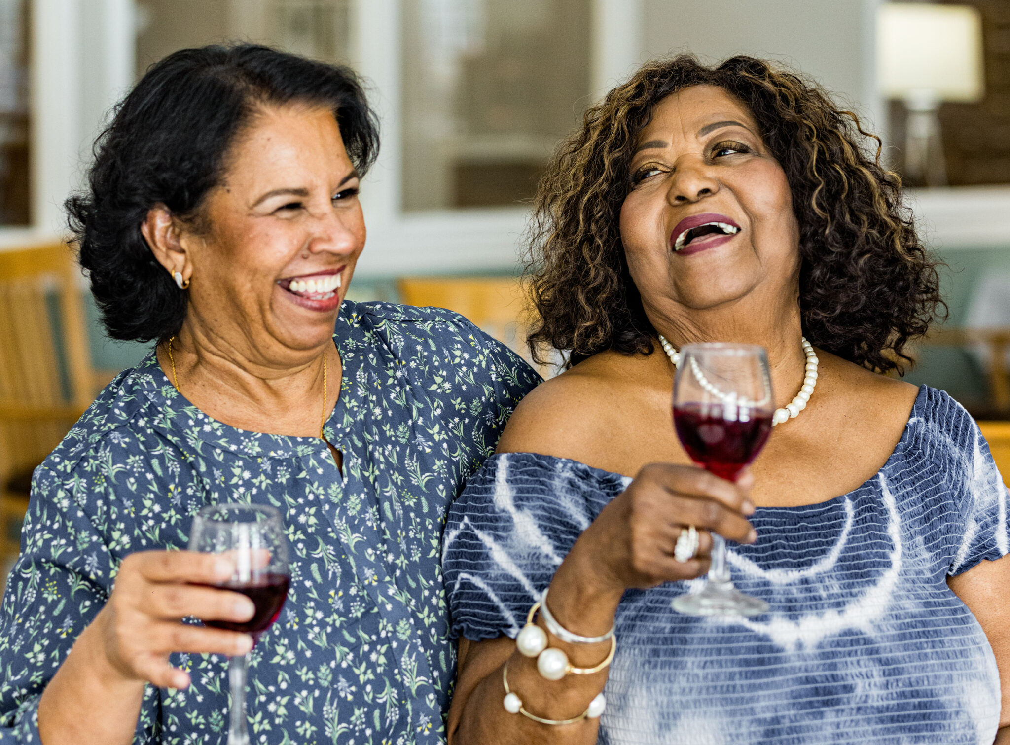 Two female residents drinking wine and laughing